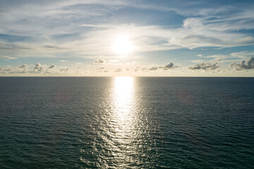 Obraz premium Aerial view of a blue sea surface water texture background and sun reflections Aerial flying drone view Waves water surface texture on sunny tropical ocean in Phuket island Thailand