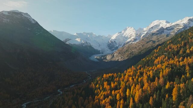 Golden hour sunset of Alpine valley during autumn season and distant Glacier