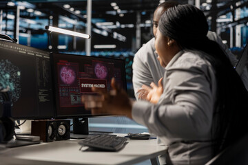 Technicians in data center viewing hacking security breach alert of zero day exploit vulnerability....