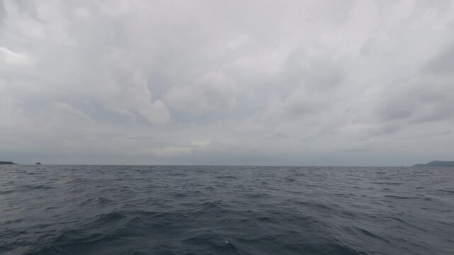 Slow motion front view from boat in Indian ocean sailing between Seychelles islands before storm