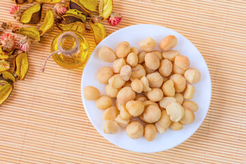 Bowl of macadamia nut and oil