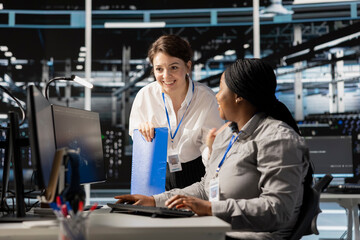 Teamworking colleagues in server hub pleased after successful operations. Happy data center...