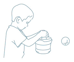 Young boy exerts himself to make juice from an orange using juice