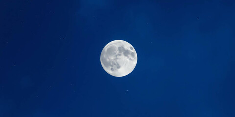 Fototapeta premium a full moon set against a backdrop of a starry night sky. The moon is centrally positioned, dominating the composition with its bright, luminous surface