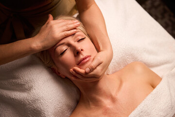 Mature woman during relaxing head massage