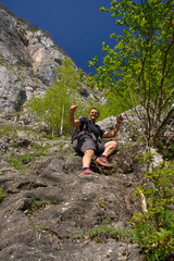 Man resting on rocky ledge