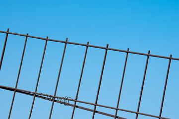 tilted metal grate against blue sky