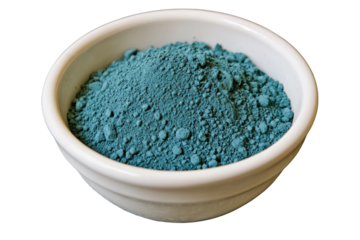 Deep teal powder in small white bowl