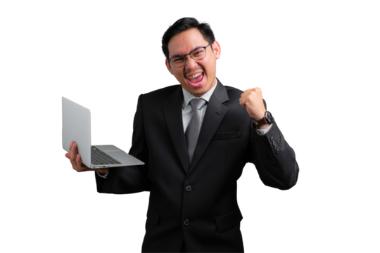 Handsome Asian businessman in suit celebrating success with laptop and raised fist, isolated on transparent background