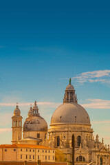Cover page with Basilica di Santa Maria della Salute at beautiful calm sunset and blue sky with copy space Venice, Italy. Concept of religion and historical heritage.