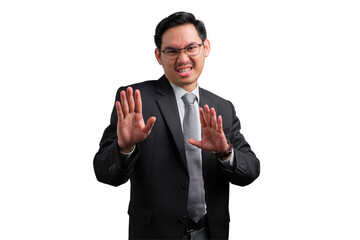 Handsome Asian businessman in suit showing stop gesture with both hands, isolated on transparent...