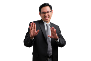 Handsome Asian businessman in suit showing stop gesture with both hands, isolated on transparent background
