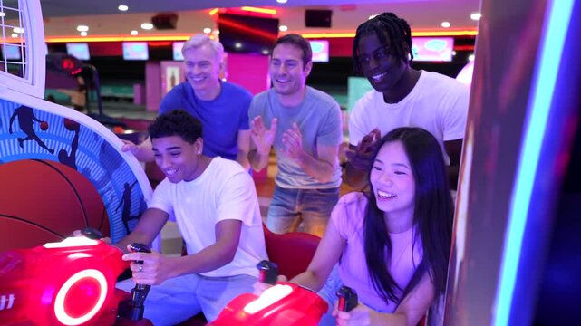 Friends playing arcade basketball game together