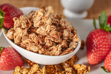 Bowl of Homemade Oat Granola with Fresh Strawberries