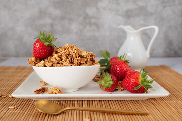 Homemade oat granola with fresh strawberries served in a bowl for a healthy breakfast