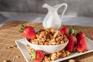 Homemade oat granola with fresh strawberries served in a bowl for a healthy breakfast