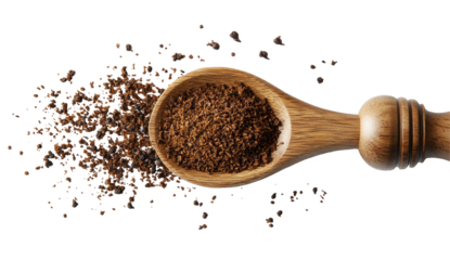 Wooden spoon filled with ground coffee, scattered around