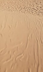Dry, sun-baked beach sand, textured surface showing fine details, shadows cast by uneven surface ,  photography,  beach