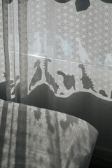 Nursery room with dinosaur shadows on curtain.