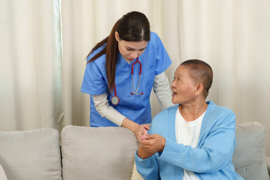Physiotherapist gently examines elderly patient’s hand, providing thoughtful care and closely monitoring mobility and progress during therapy. - Powered by Adobe