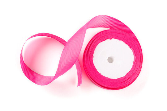A fuchsia-colored turnip ribbon on a white insulated background. Bright pink tape Close-up. The isolate.