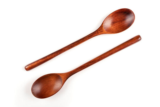 A pair of brown wooden spoons (tablespoons) on a white insulated background.