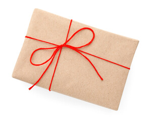 Gift wrapped in kraft paper with bow isolated on white, top view