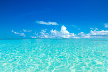 Beautiful beach. Tropical beach. Holiday and vacation concept. Sand, blue sea water, turquoise ocean, sun sky white clouds