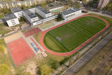 School Complex with Sports Fields and Urban Landscape - Aerial View