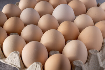 Brown eggs stacked in rows.Group of Fresh white Eggs in a cardboard cassette. Organic food from nature good for health.