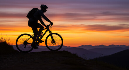 Fototapeta premium Silhouette of Cyclist at Sunset Mountain Bike Ride