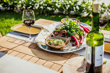 Delicious Grilled Steak meat with Sides BBQ Lunch with wine on nature in park by summer.