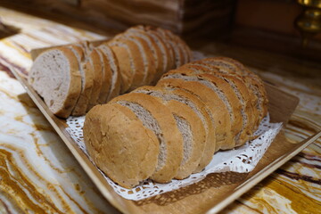 Slices of bread on a wooden plate, close-up
