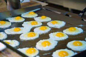Close-up of Freshly Fried Sunny-Side-Up Eggs on a Griddle