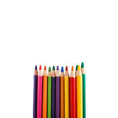 Variety of colored pencils arranged in a row on a white background