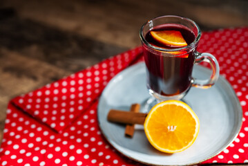 Hot mulled wine with cinnamon stick and orange slice