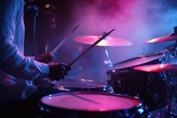 Drummer plays under vibrant stage lights.