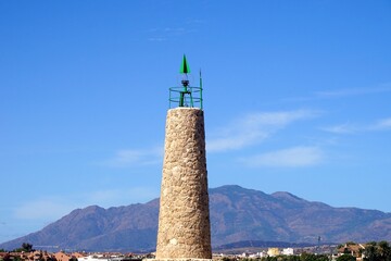 Obraz premium Faro Puerto Banús lighthouse at the famous habor Puerto Banús with luxury yachts, Marbella, Malaga, Costa del Sol, Spain
