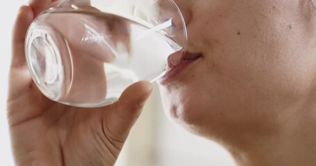 Young woman drinking glass of water