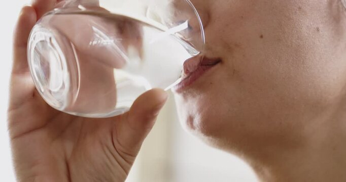 Young woman drinking glass of water