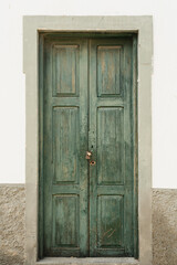 Quaint door set adorned an aged wall. Vintage allure