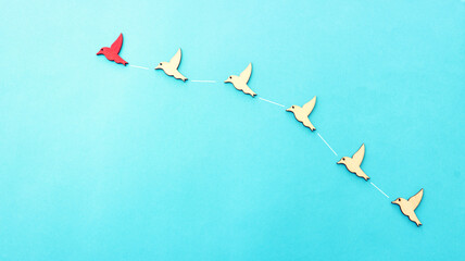 Concept image of birds following the leader. Idea of teamwork and moving ahead