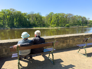 Retired couple sitting on the banks of the Elbe in nice weather in spring