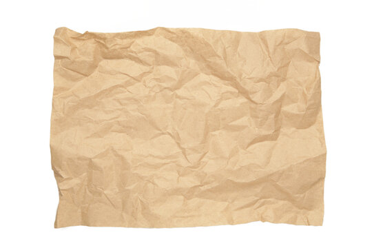 Crumpled piece of beige parchment or baking paper isolated on white background. Copy space for text and design element.