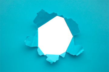 Torn ripped blue paper hole isolated on white background