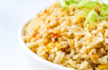 close up of a bowl of fried rice isolated on white background