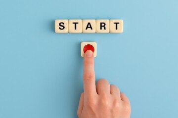 A finger pressing a red start button below the word START on a pastel blue background, symbolizing beginning, decision-making, or taking action.