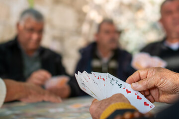 The village elders are playing cards in the coffeehouse.