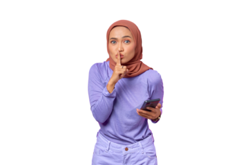 Beautiful young Asian woman holding mobile phone and makes silence gesture isolated on transparent background