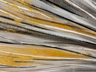 Close up of abstract gold and grey black painting in random sunburst pattern and brush strokes. Antique and unique gold and black and white paint for decoration. Seamless background texture. 
